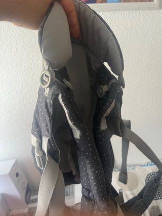 Mochila portabebés gris con estrellas.