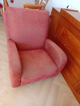 Sillón reclinable de tela rojo.