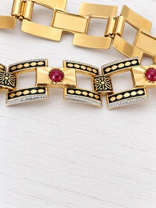 Pulsera chapada en oro con piedrss rojo esmeralda