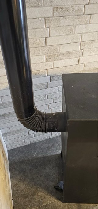 Estufa de leña negra con puerta de cristal