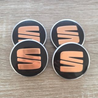 TAPABUJES SEAT 56mm NEGROS CON EMBLEMA COBRE