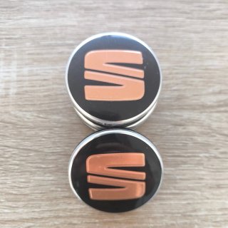 TAPABUJES SEAT 56mm NEGROS CON EMBLEMA COBRE
