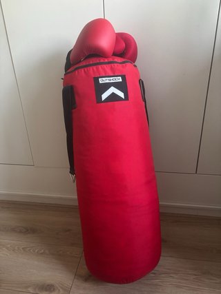 Saco de boxeo rojo con guantes