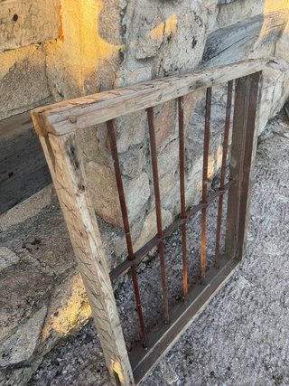 Reja antigua de forja con marco de madera