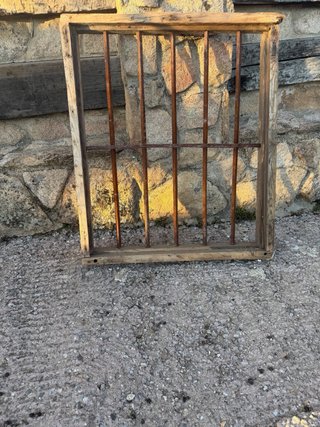 Reja antigua de forja con marco de madera