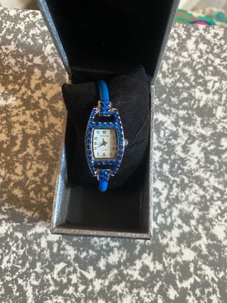 Reloj de pulsera plateado con pedrería azul