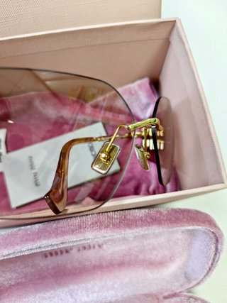 Gafas Miu Miu doradas sin montura
