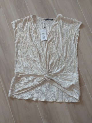 Blusa beige y dorada con nudo