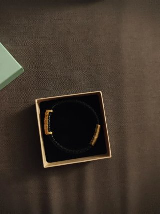 Pulsera de cuero trenzado con detalles dorados