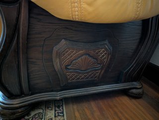 Sofá de cuero y madera tallada