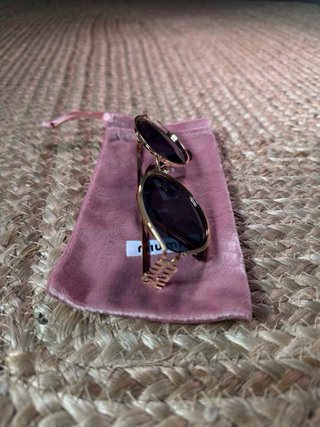 Gafas Miu Miu doradas