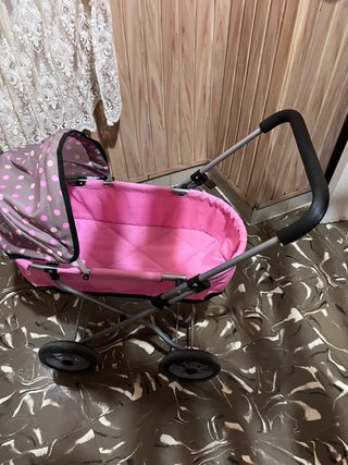 Carro para muñecas rosa con capota