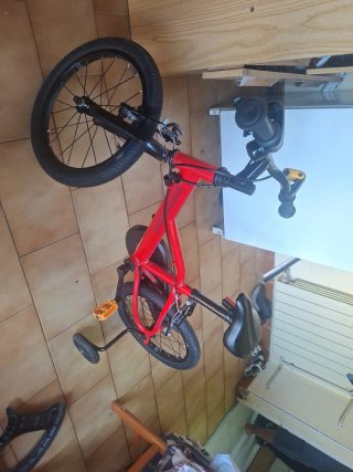 Bicicleta infantil roja con ruedines
