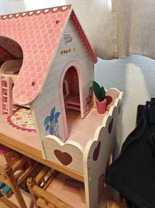 Casa de muñecas rosa con muebles