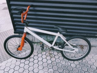 Bicicleta BMX blanca y naranja