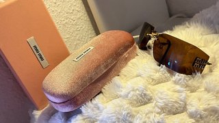 Gafas de sol Miu Miu marrones y doradas
