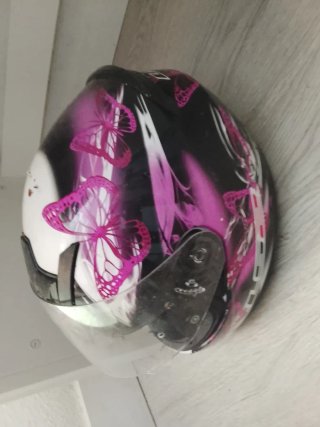 Casco de moto rosa con mariposas