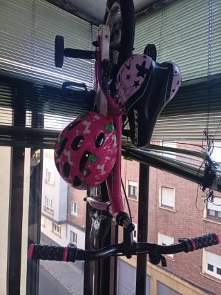 Bicicleta infantil rosa con casco