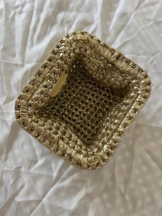 Bolso de mano dorado tejido