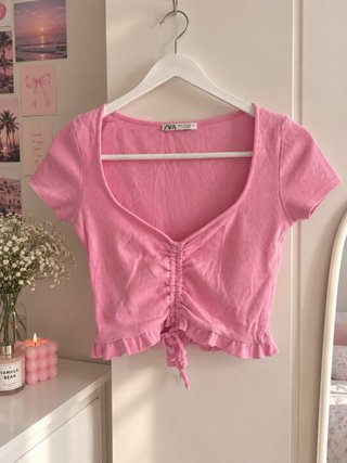 Top rosa con volantes