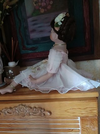 Muñeca de porcelana con vestido rosa