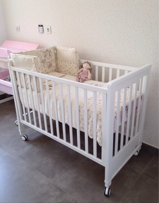 Cuna de bebé blanca con ruedas
