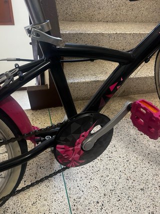 Bicicleta urbana rosa y negra con cesta