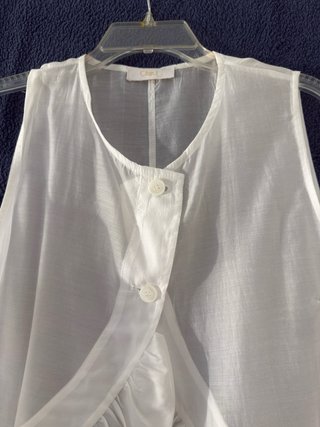 Blusa blanca sin mangas con volantes