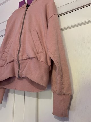 Sudadera rosa con cremallera y capucha de pelo