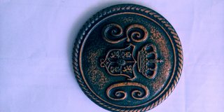 Medalla antigua con corona y monograma