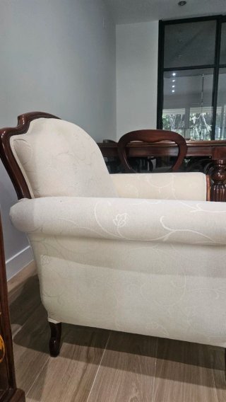 Sillón clásico tapizado, con estructura de madera