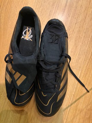 Botas de fútbol negras y doradas de  Bellingam