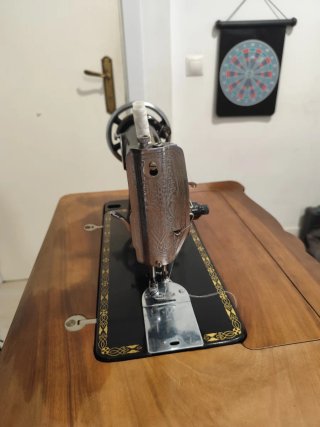 Máquina de coser antigua en mueble de madera