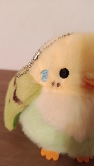 Peluche periquito en nido