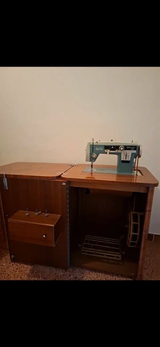 Máquina de coser antigua en mueble de madera