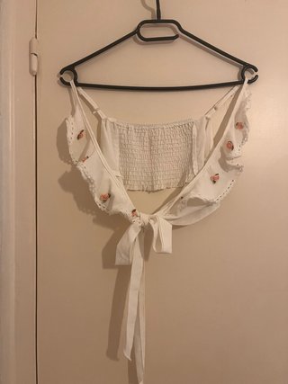 Top corto blanco con flores rosas