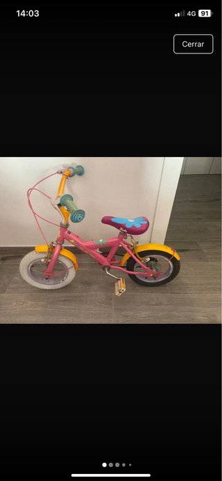 Bicicleta infantil rosa y amarilla tal se ve