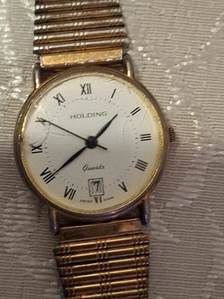 Reloj Holding Oro y Blanco
