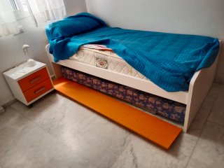 Habitación juvenil con cama y estantería