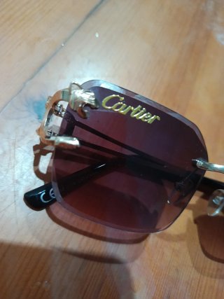 Gafas de sol Cartier doradas y moradas