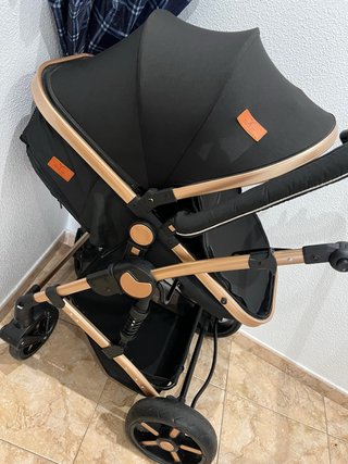 Carrito de bebé negro y dorado