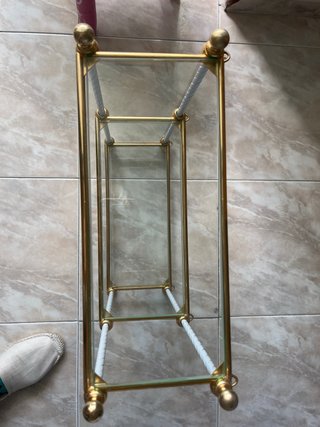 Estantería de cristal y metal dorada