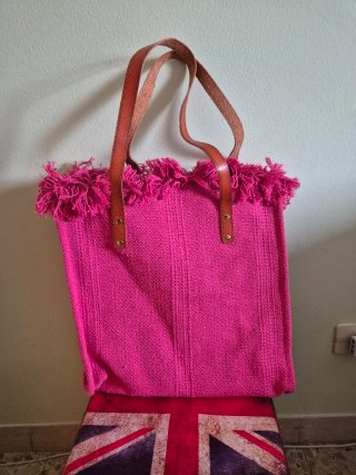 Borsa fucsia in tessuto con frange