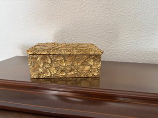 Caja decorativa dorada con hojas