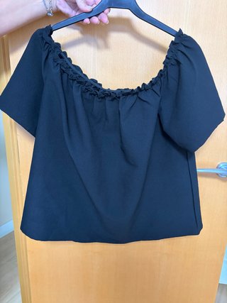 Blusa negra escotada con volantes