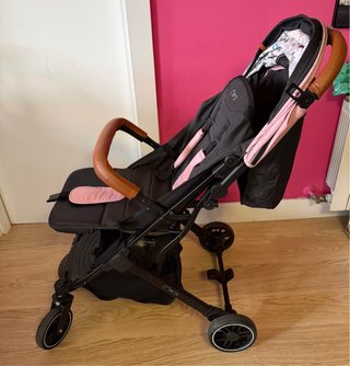 Silla de paseo compacta negra y rosa