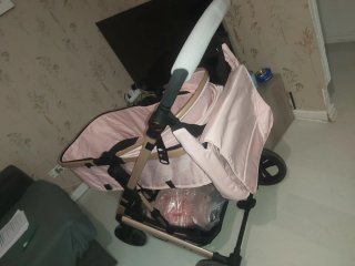 Carro de bebé rosa y dorado