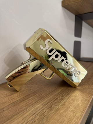 Pistola de Billetes Supreme Dorada