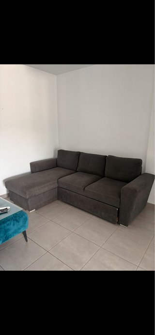 Sofá cama con chaise longue gris