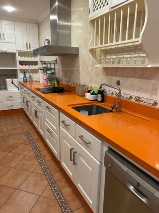 Muebles de cocina blancos y encimera naranja